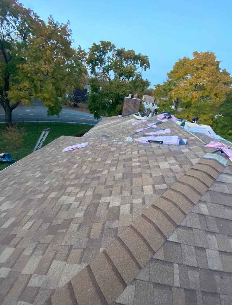 Close view of a finished architectural shingle roof and ridge cap