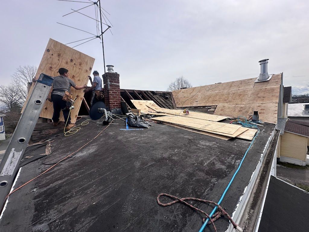 Flat roof deck being rebuilt with new plywood before membrane installation
